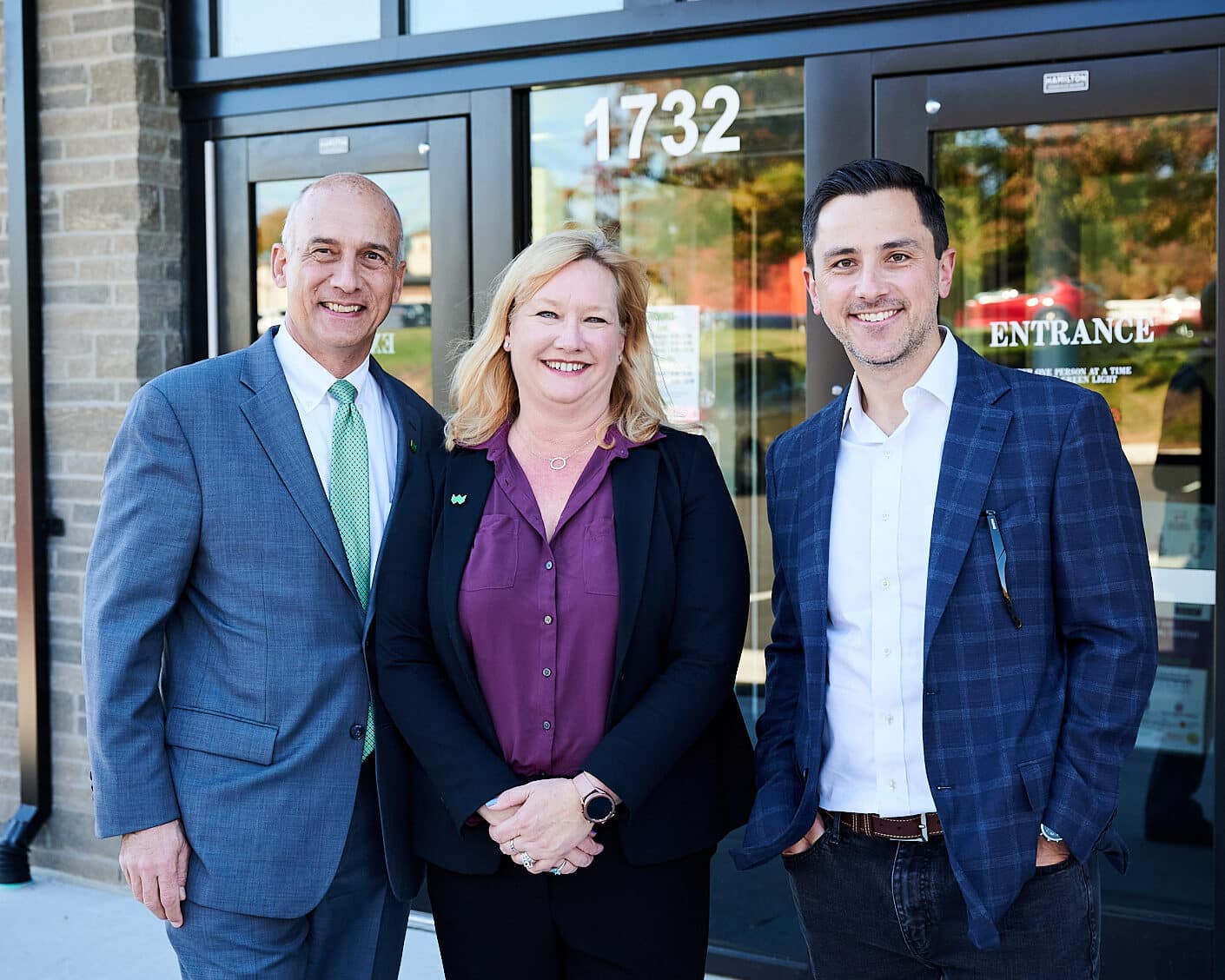 Professional corporate event photograph of two WesBanco Executives and a local politician, attending the WesBanco Pikesville branch ribbon cutting ceremony, dressed in suits, taken by corporate event photographer Heidi Marie Bell.